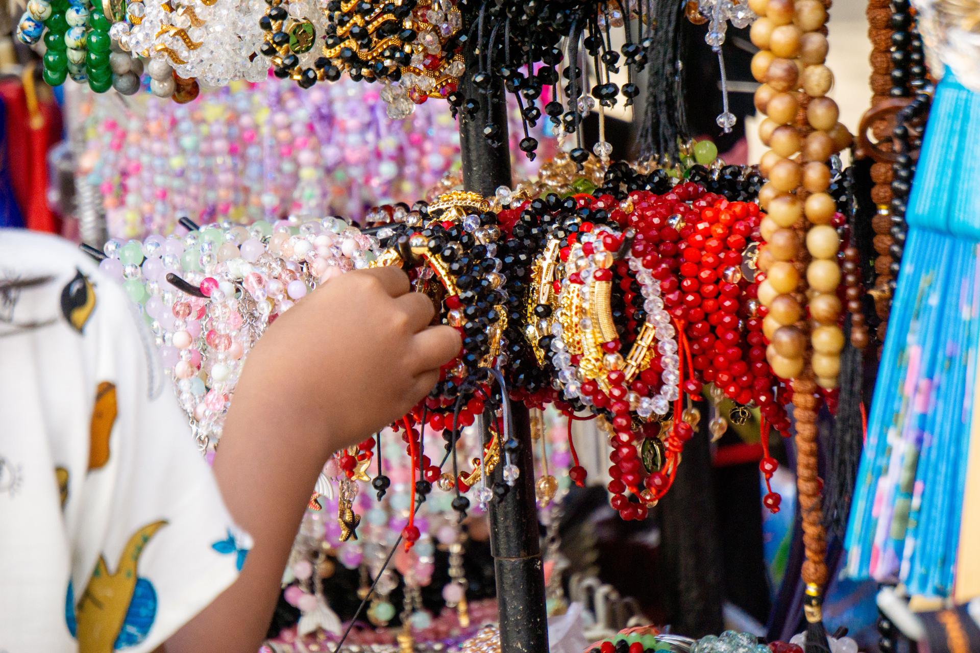 Various types and models of beaded bracelets are arranged on display.